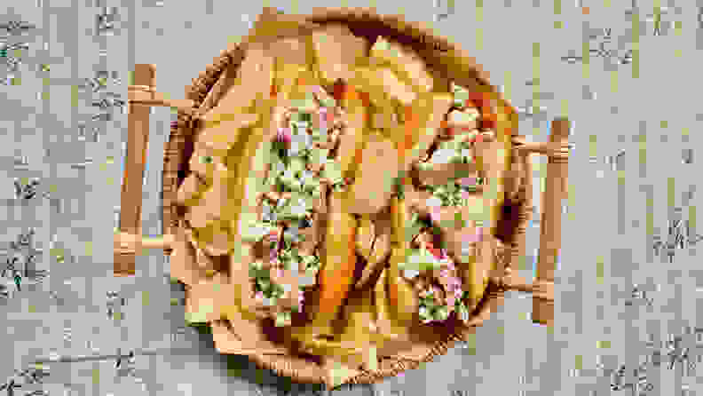 In the center of the image, two lobster rolls were surrounded by Cape Cod Kettle Cooked Potato Chips in a wicker tray.