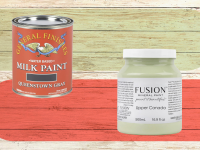 Two pint cans of our best furniture paints on a wood background with colored stripes