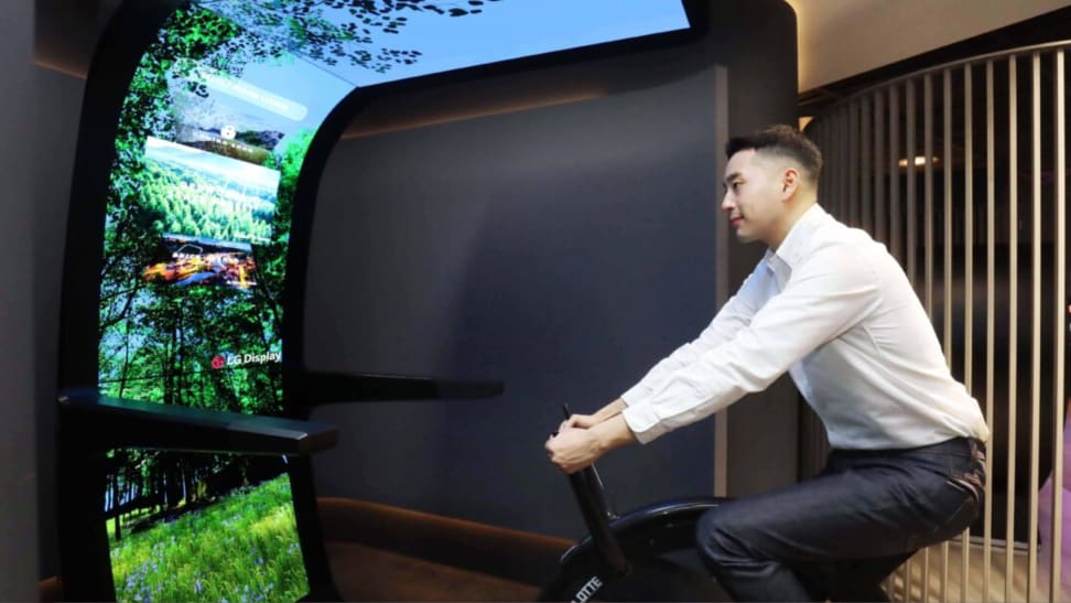 A man riding an exercise bike with LG virtual ride.
