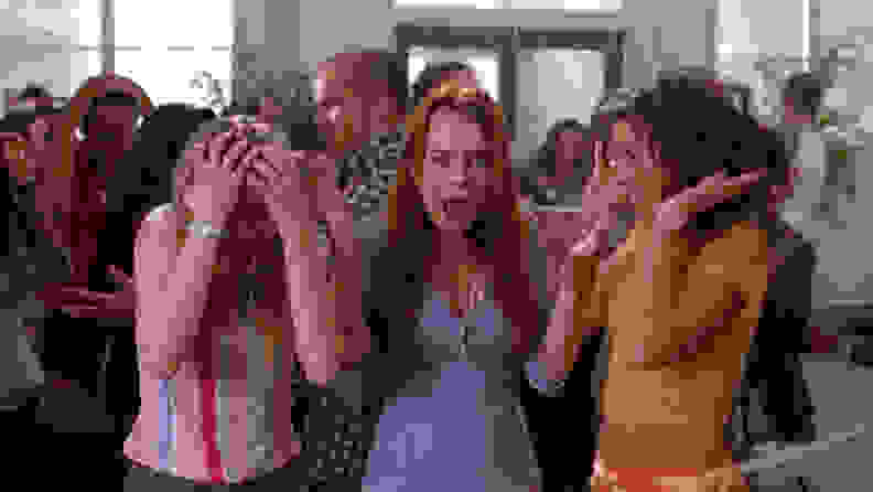 Cady (Lindsay Lohan), Karen (Amanda Seyfried), and  Gretchen (Lacey Chabert) being doused by a fire extinguisher.