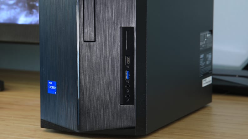 A black Acer desktop computer is sitting on a table.
