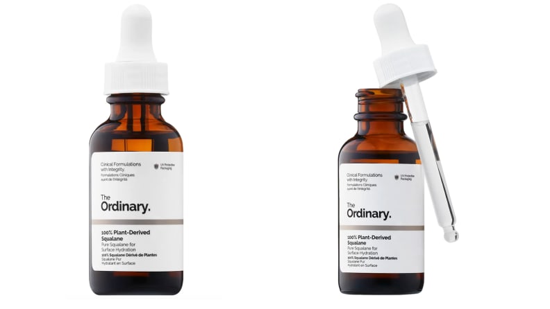 Two amber colored bottles of serum on a white background.