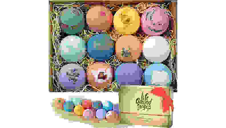 Assorted bath bombs in box on white background