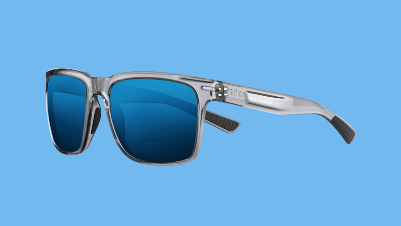 The Roka sunglasses on a blue background.