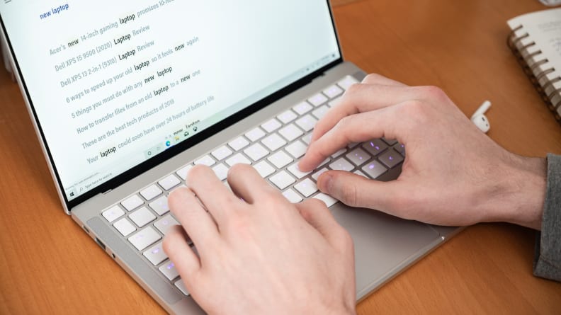 person types on a laptop's keyboard