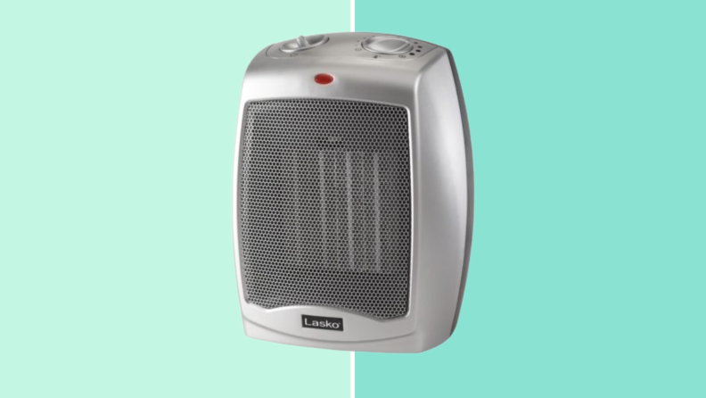 A silver space heater on a green background
