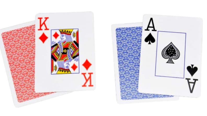 Two packs of playing cards, one blue and one red.
