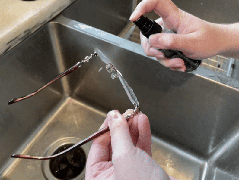 Gif of author spraying glasses with cleaner over sink