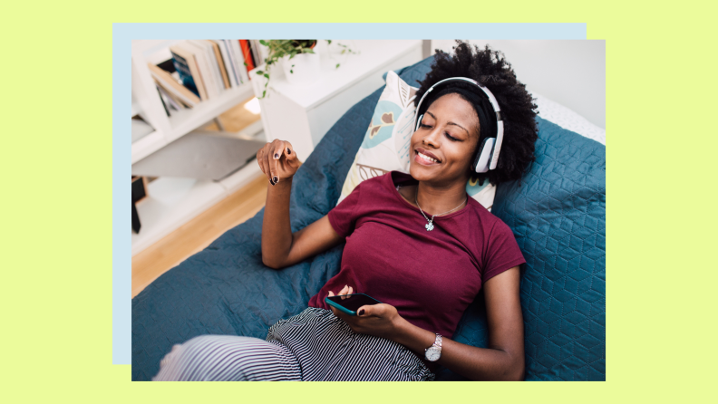 A person relaxes by listening to music at home.