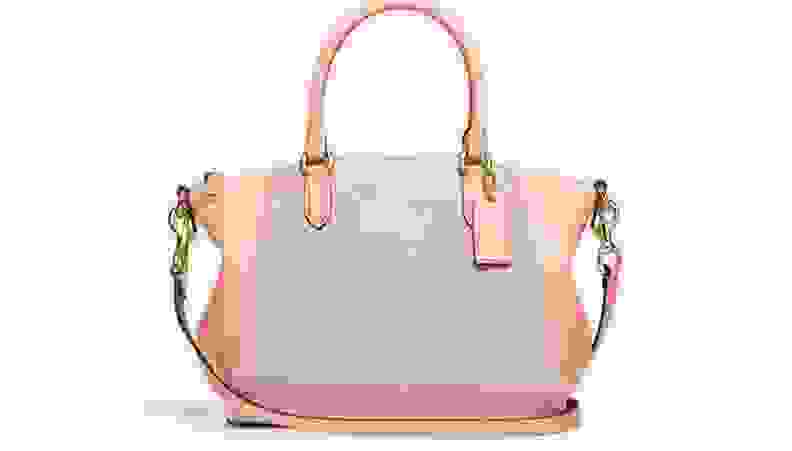 Pink Coach purse against white background.