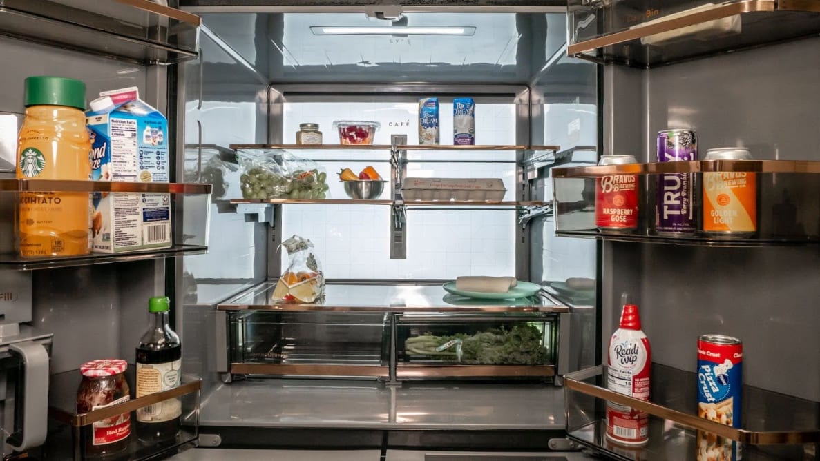 A close-up of the fridge's interior, fully stocked with food and lit by its interior LED back panel.