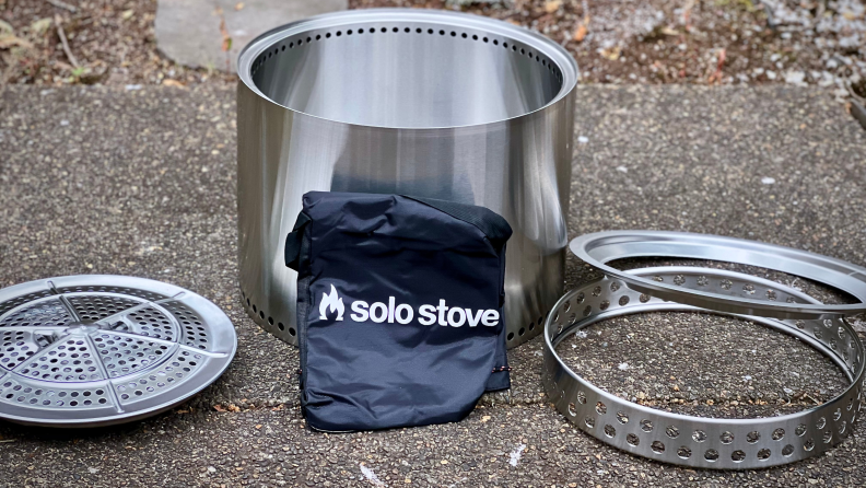 Solo Stove Fire Pit 2.0 unassembled on ground outdoors.
