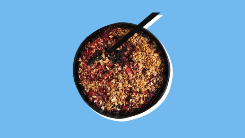 A small bowl of berry crisp with matzo.