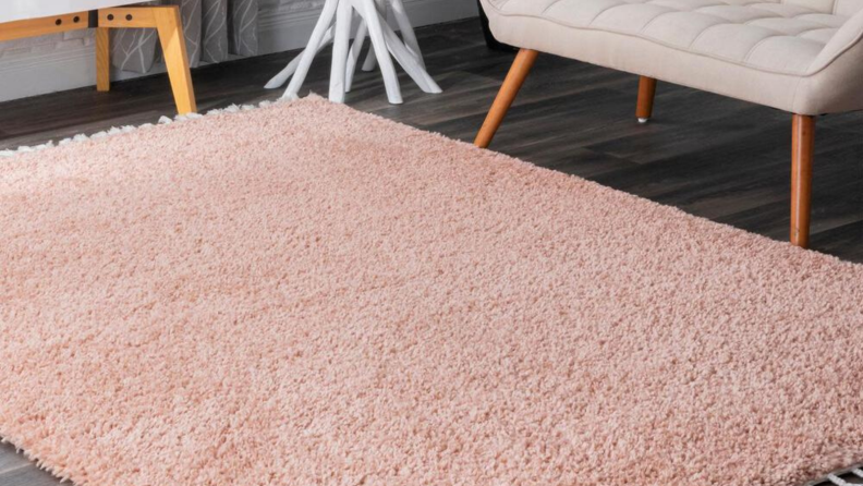 A plush, pink rug with tassels.