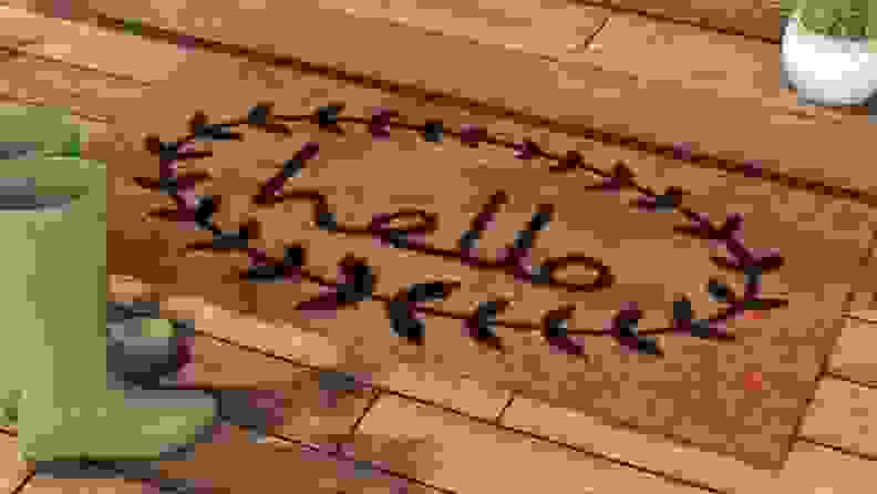 Welcome mat in front of a door with the word "hello" on it