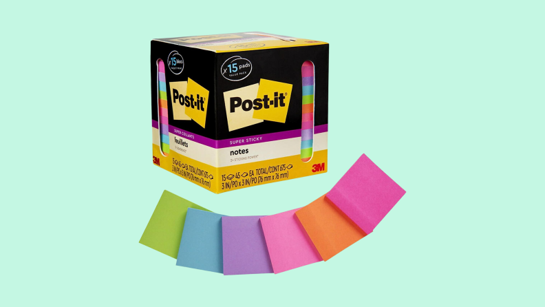 A pack of Post-It Super Sticky Notes with several empty notes arrayed around it in green, blue, purple, pink, orange, and mauve.