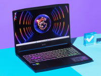 An open and powered on black laptop with a neon-lit keyboard against a purple and blue backdrop.