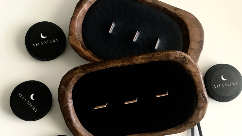 Two black wax candles in hand-crafted dough bowls