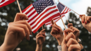 Hands holding up small American flags