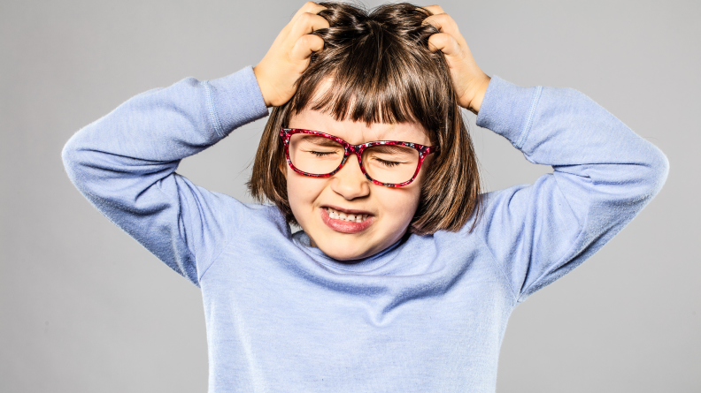 A child scratching their scalp.