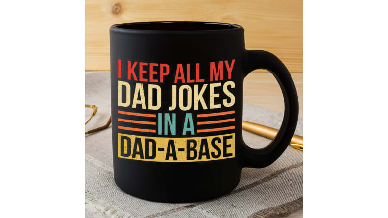 Black mug that says "I Keep All My Dad Jokes In A Dad-A-Base"