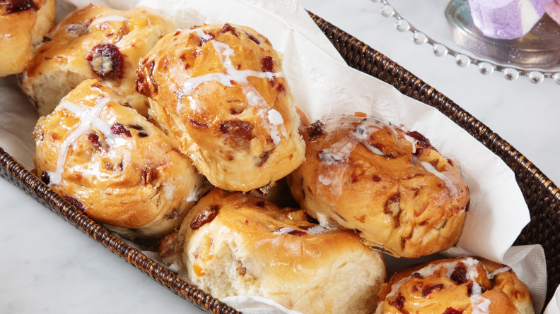 A basket piled with hot cross buns.