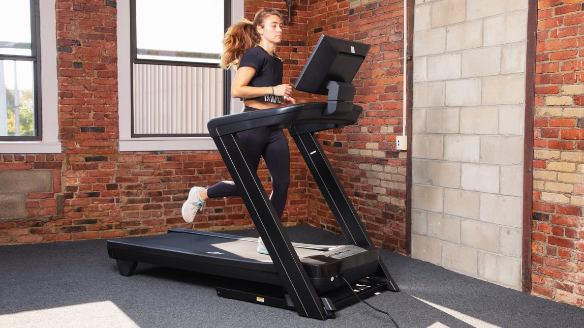 A woman running on the NordicTrack Commercial 1750 treadmill.