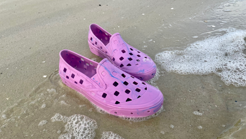 pair of Vans Trek Slip-On shoes on beach shore