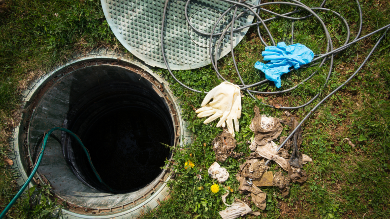 An open manhole cover of a septic tank.