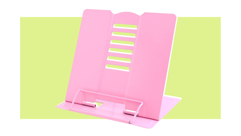 A pink camelmother book stand It's angled and has a small bar to hold a book in place.