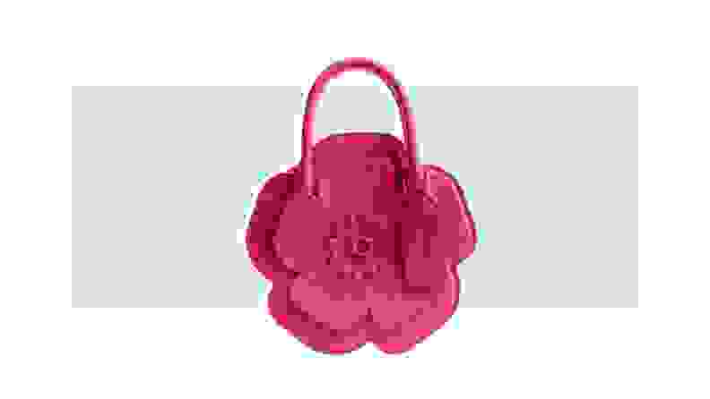 A small pink leather handbag that is designed to look like a flower.