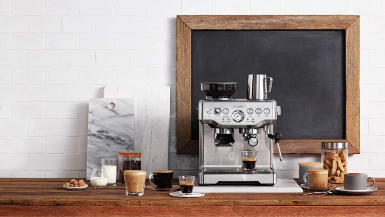 A Breville espresso machine sits on a counter.