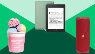 bath bombs, e-reader and red portable speaker on a green background