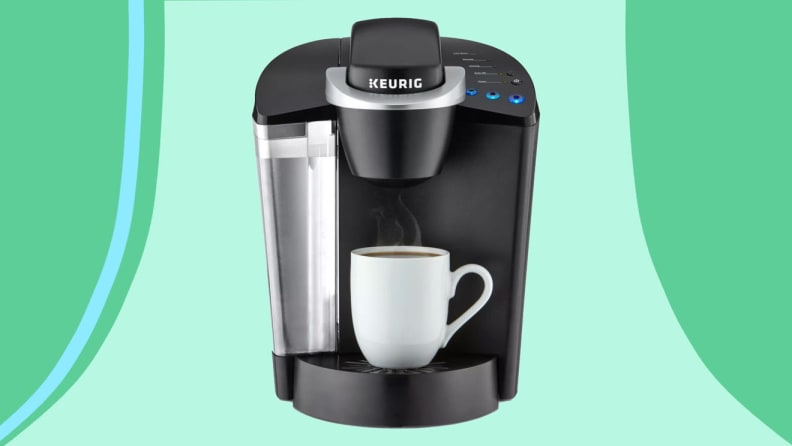 Single-serve coffee maker in front of green and blue background.