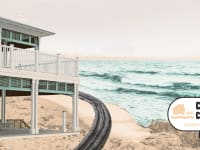 Residential home on coastal shore in front of ocean.