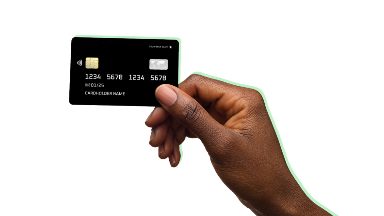 Person holding plastic credit card in fingers.