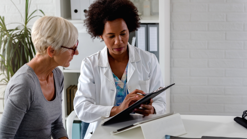 An older woman consulting with a doctor about test results