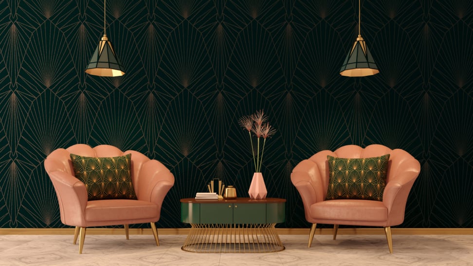 An Art Deco inspired sitting room with two pink armchairs and green accent table.