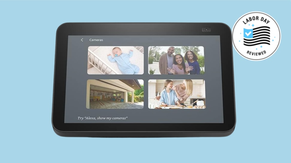The Amazon Echo Show 8 smart screen shows images of families, a baby, and a garage. It is shown over the Reviewed background.