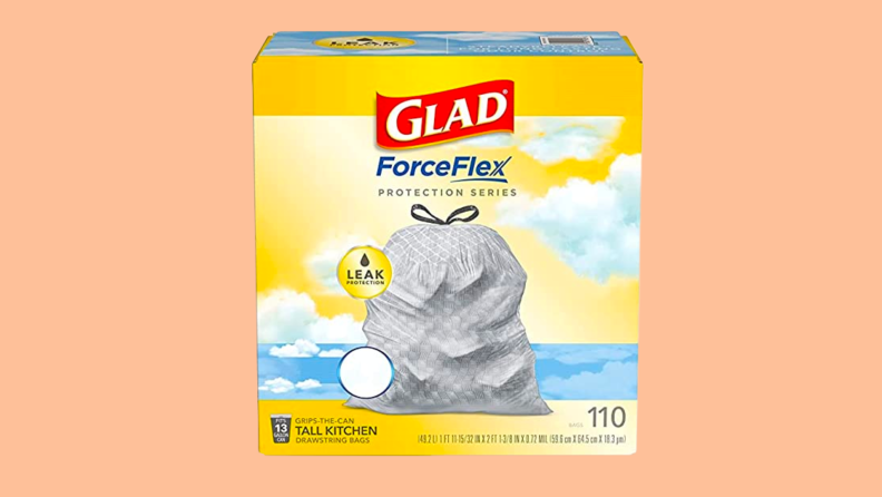 A box of Glad trash bags against a peach background