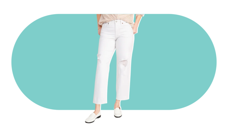 A model wearing the Old Navy High Waisted OG Loose Ripped White Jeans in white.