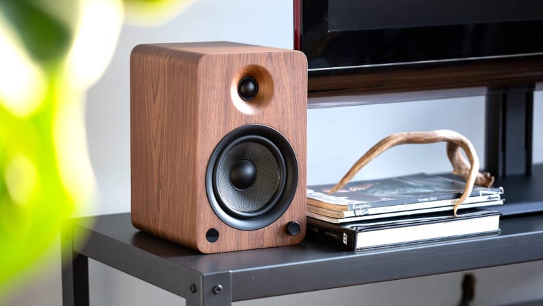 A stand-alone audio speaker next to a turntable