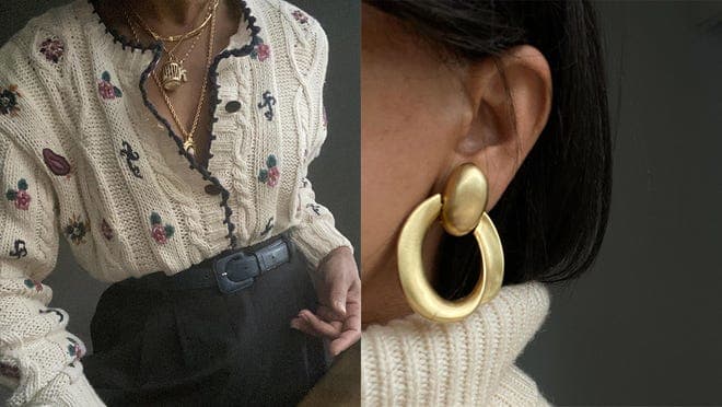 A person wearing a white knitted sweater with flower details and a person wearing gold hoop earrings.