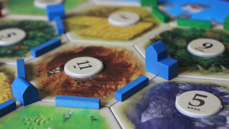 During the game, players race to build a settlement on the board.