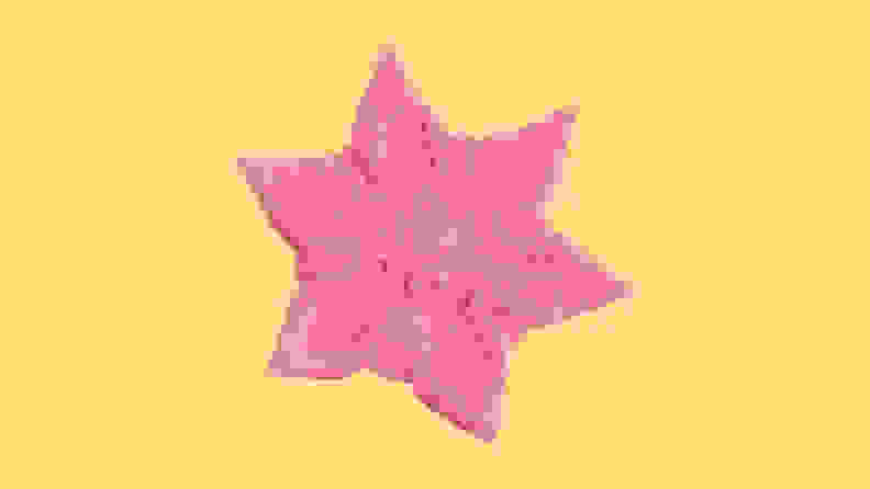 A pink Starsi starfish-shaped vibrator on a yellow background