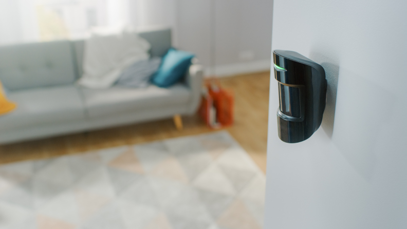 Motion sensor mounted to living room wall.