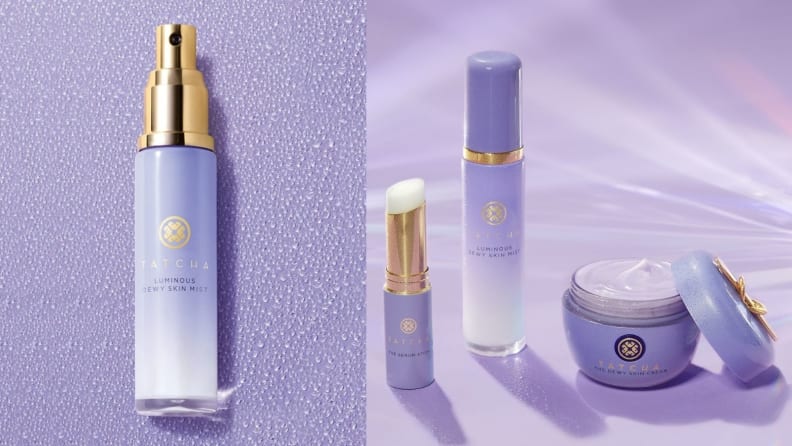 On the left: The Tatcha Luminous Dewy Skin Mist lays on a purple background in its cylindrical tube. On the right: The Tatcha mist stands on a purple background next to a moisturizer and lip balm from the brand.