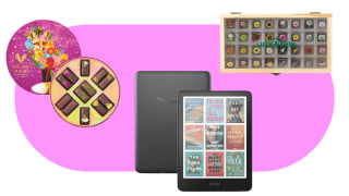 A round box of chocolates, an Amazon Kindle Colorsoft and a rectangular box of flower seeds on a pink billbox background