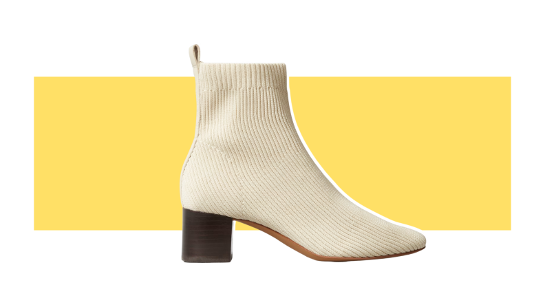 A cream-colored heeled boot with a knit upper.