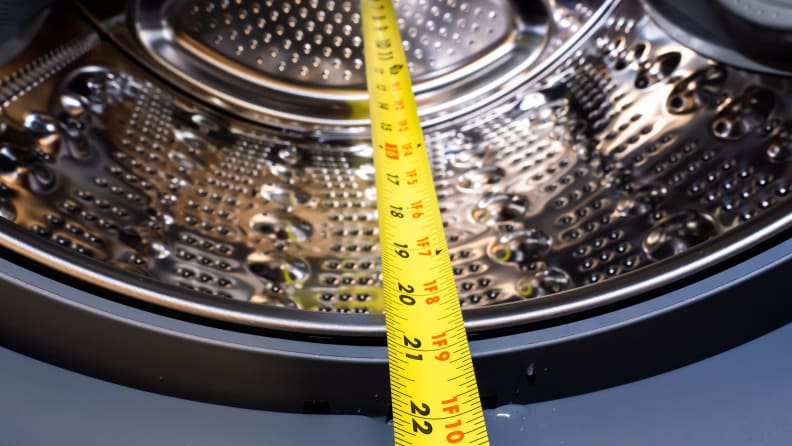 A shot of the LG WM8100HVA front-load washer drum, with the measuring tape showing the distance from the back to the front of the drum, about 21 inches.